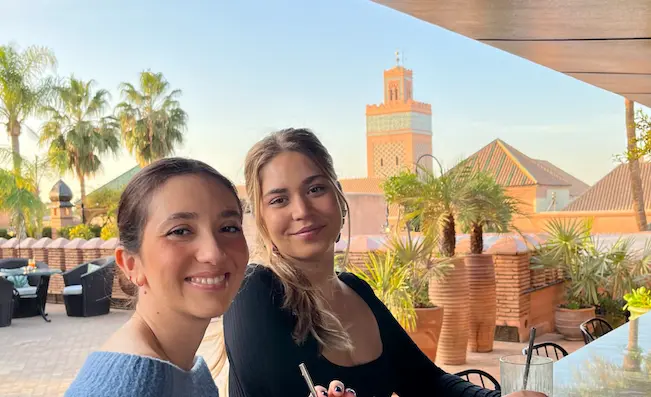 Relaxing in Marrakesh during a Morocco Jewish tour with views of the historic Koutoubia Mosque..