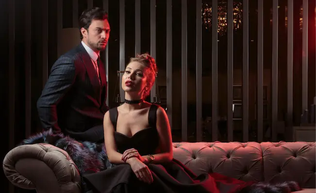 Elegant couple enjoying a sophisticated night out in Lisbon's high-end nightlife venues, as part of the Shin-Tours Luxury Tours. Experience the city's nightlife in style with exclusive access to the best venues and luxurious environments.